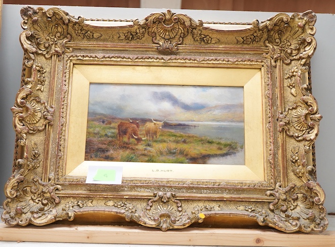 Louis Bosworth Hurt (1856-1929), Highland cattle by a loch, signed, oil on board, 12 x 23cm